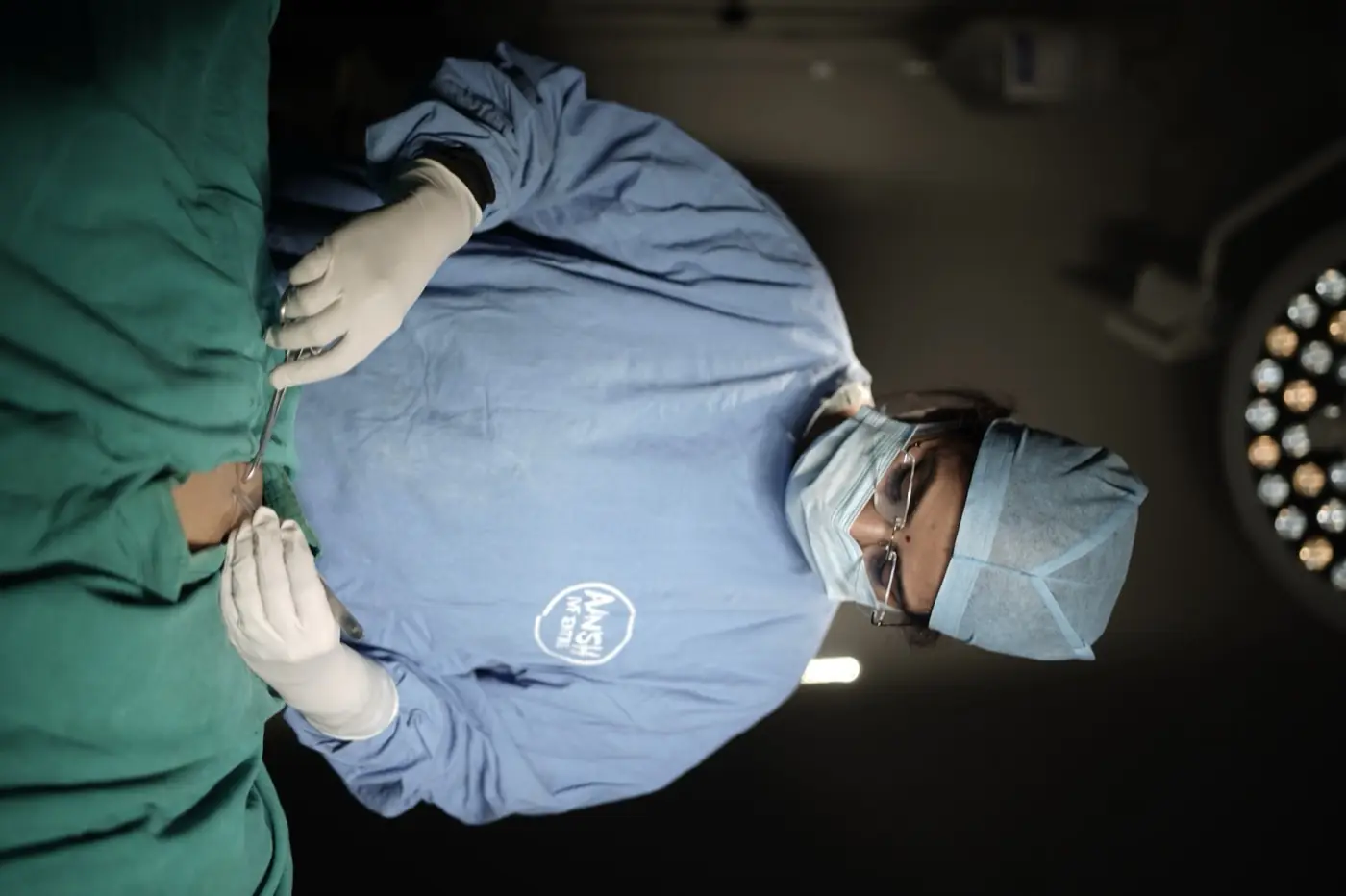 Dr. Shweta Agarwal operating under theatre lights at Aansh Hospital & IVF Center