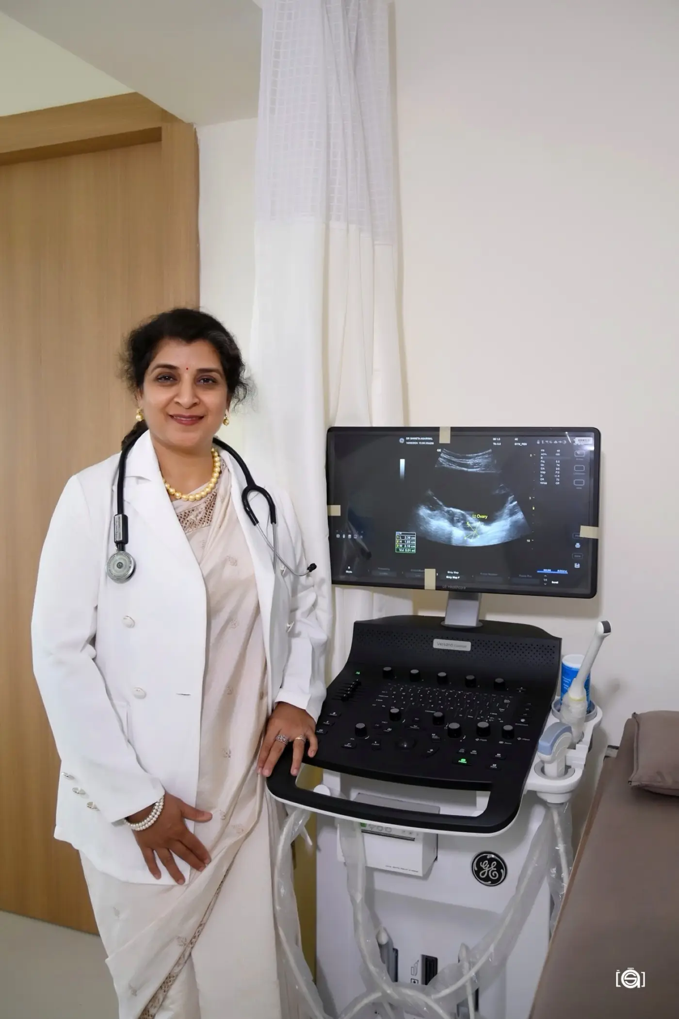 Dr. Shweta Agarwal beside the ultrasound machine in the scanning room at Aansh IVF